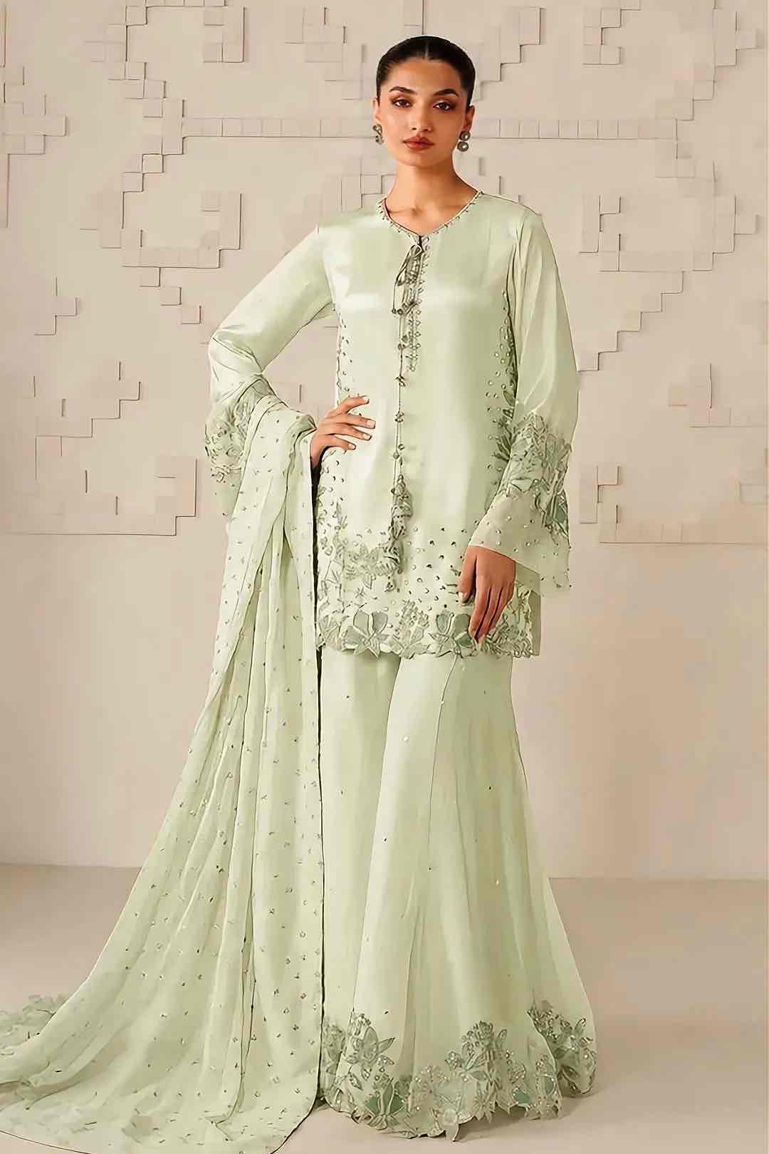 Iznik mint green chiffon embroidered gharara suit with hand crafted adda work shirt, embroidered flared gharara, and matching dupatta standing front view - Shop Now