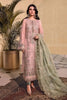 Woman in a pink embroidered outfit with a green dupatta standing indoors.