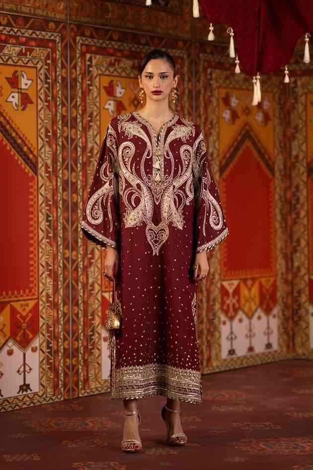 Full-length front view of a model wearing the Zellbury maroon embroidered silk kaftan by pkclothing.pk with heavy paisley motifs and embellished hem. Shop now till stock lasts!