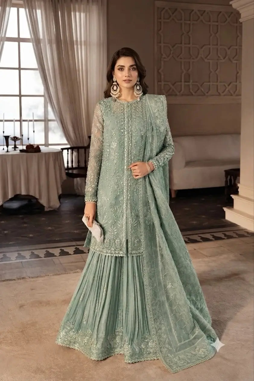 Women wearing Soraya green organza partywear dress featuring a fully embroidered handwork shirt and crush silk gharara.