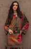A woman models a traditional patchwork embroidered kurta in olive green, pink, and orange, set against a textured brown stucco wall.