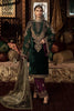 Woman in traditional green and purple outfit with intricate patterns in a decorated room.
