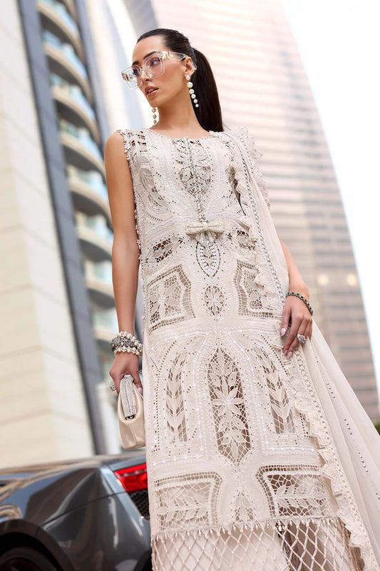 Woman wearing a white lace dress standing in an urban setting with tall buildings.